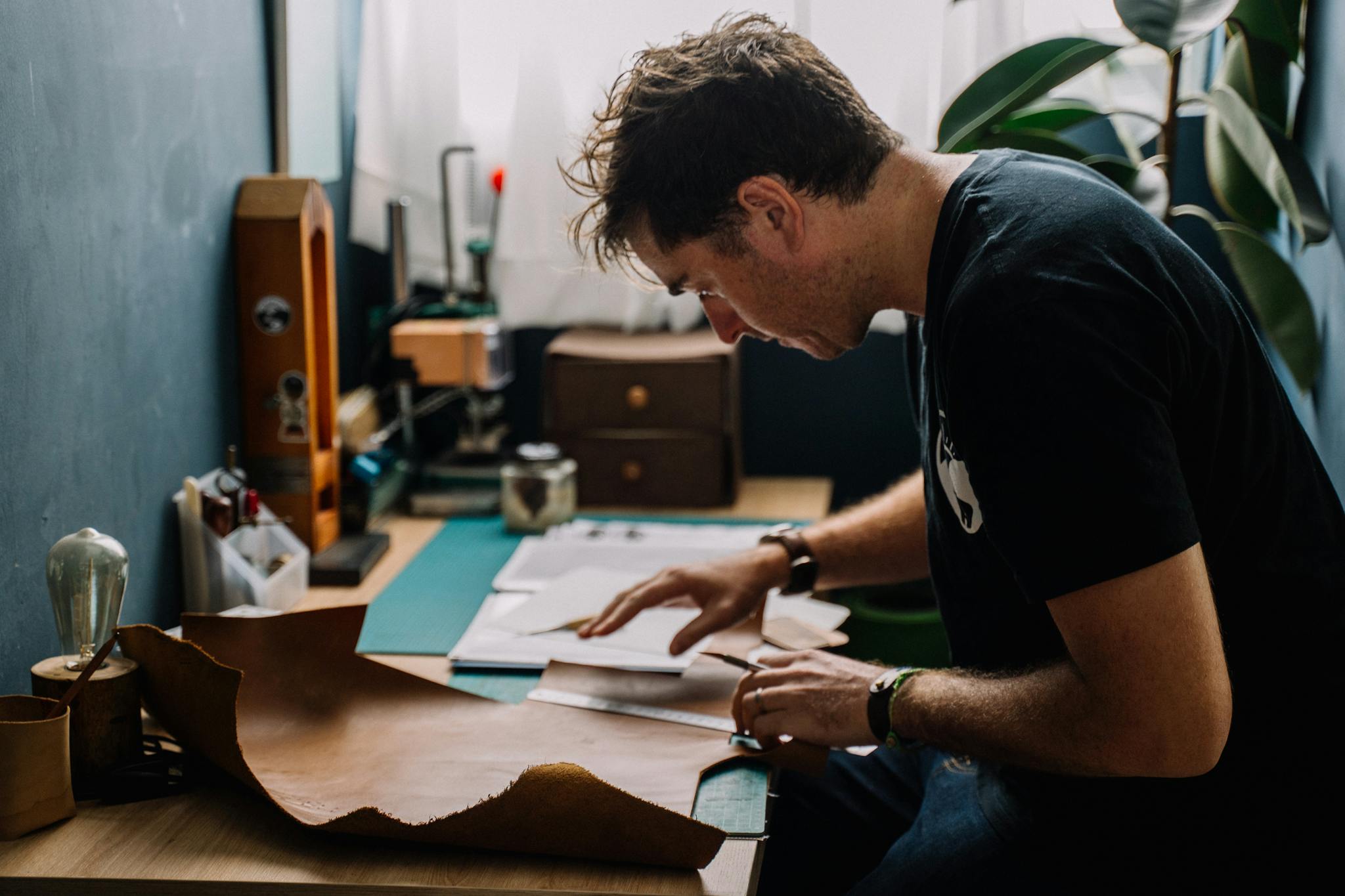 A Man Cutting Leather in His Workshop